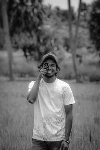 Portrait of smiling man standing on field