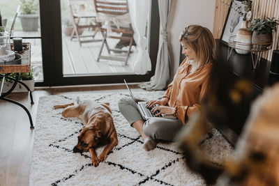 Businesswoman using laptop at home