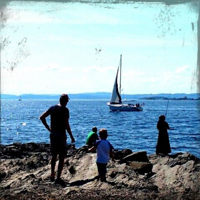 water, sea, men, nautical vessel, transportation, lifestyles, mode of transport, rear view, leisure activity, horizon over water, boat, full length, person, togetherness, travel, sky, nature, standing