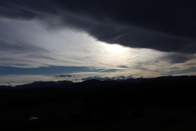 Scenic view of silhouette mountain against dramatic sky