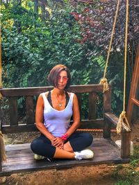 Full length of woman sitting on swing