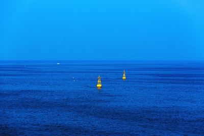 Scenic view of sea against clear blue sky