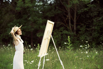 Side view of person holding umbrella on field