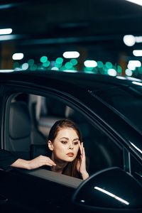 Young woman sitting in car