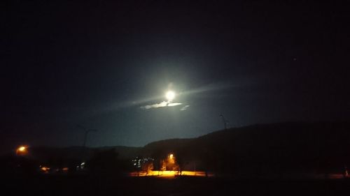 Scenic view of illuminated mountains against sky at night