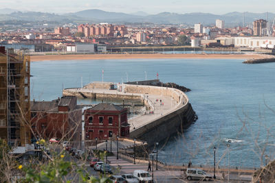 High angle view of buildings in city by the sea