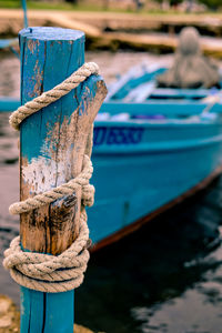 Close-up of fishing boat on wooden post