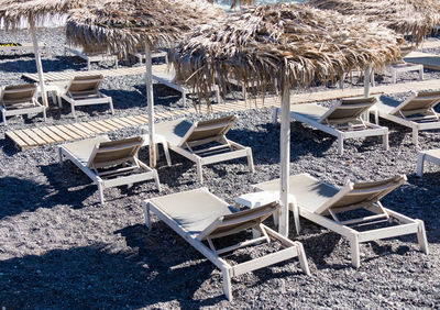 High angle view of empty chairs and tables at beach