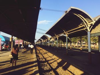 Man walking on bridge in city