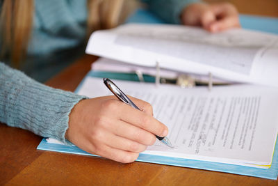 Midsection of woman working on table