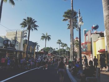 People on street in city against clear sky