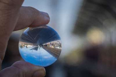 Close-up of hand holding sunglasses