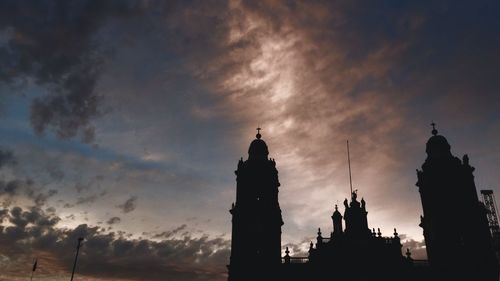 Low angle view of building against cloudy sky