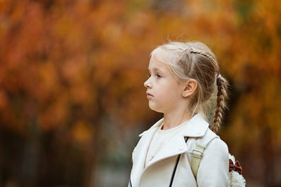 Girl looking away outdoors during autumn