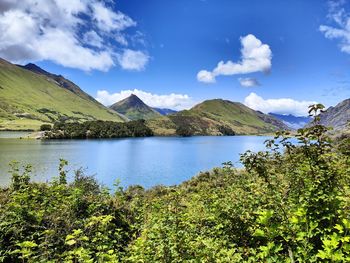 Scenic view of lake and mountains against sky