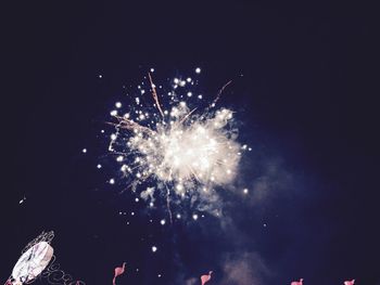 Low angle view of firework display at night