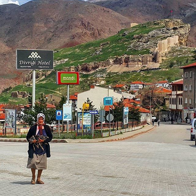 WOMAN STANDING ON ROAD