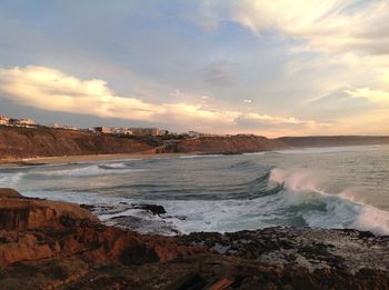 Scenic view of beach against sky during sunset