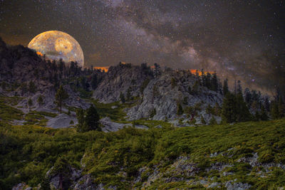 Scenic view of mountains against sky at night