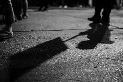 Low section of people walking on road