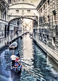 Boats in river with city in background