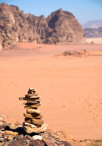 Stack of rocks on sand at desert