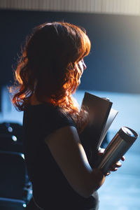 Midsection of woman holding smart phone