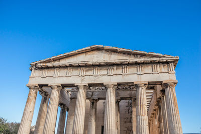 Low angle view of historical building against blue sky