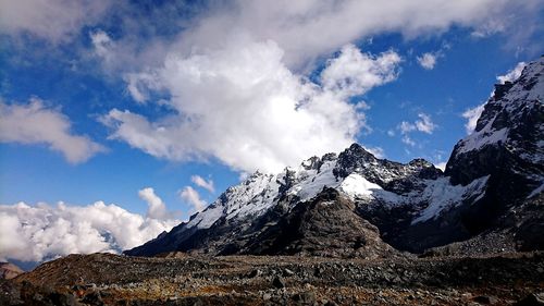 Low angle view of snowcapped mountains against sky