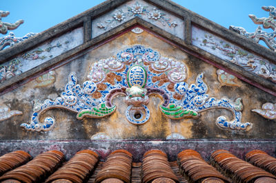 Low angle view of ornate statue against sky