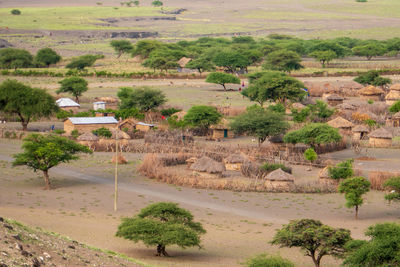 Masai villages against mountains at mount ol doinyo lengai in ngorongoro conservation area, tanzania