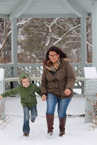 Full length portrait of boy standing in snow