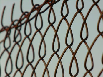 Full frame shot of chainlink fence against sky