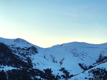 Scenic view of snowcapped mountains against clear sky