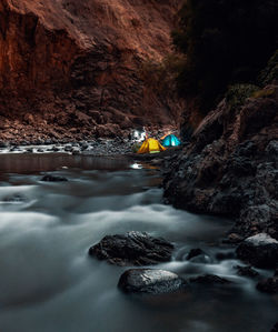 River flowing amidst rock formations at night