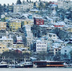 Boats moored at harbor in city