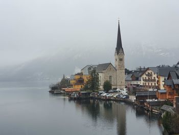 River amidst buildings against sky