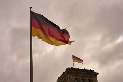 Low angle view of flag flags against sky