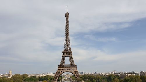 Tower of building against cloudy sky