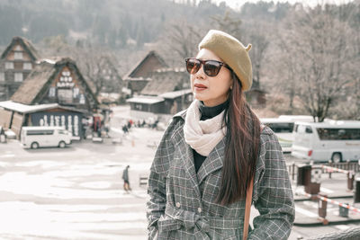 Portrait of beautiful young woman standing in park