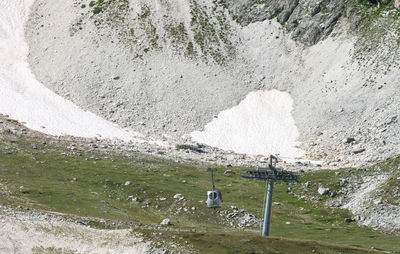 High angle view of rocks in mountain and cable car