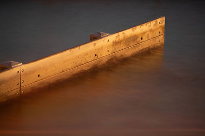 High angle view of wooden posts in lake against sky