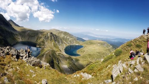 Panoramic view of people on landscape against sky