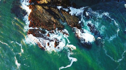 High angle view of rocks in sea