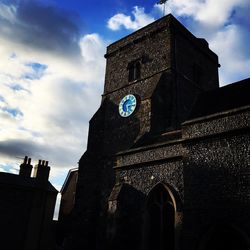 Low angle view of clock tower against sky