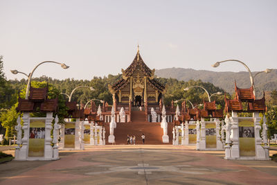 Temple against building against clear sky