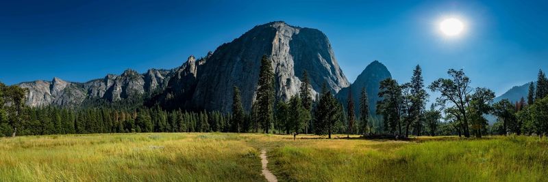 Panoramic view of landscape against clear blue sky