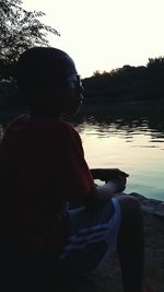 Rear view of woman looking at lake