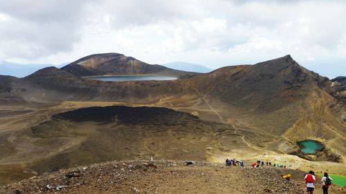 Panoramic view of people on mountain against sky