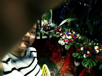 Close-up of young woman with flowers in hair